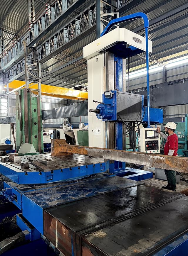 A flanged forging set up on the table of the Shibaura CNC boring machine.